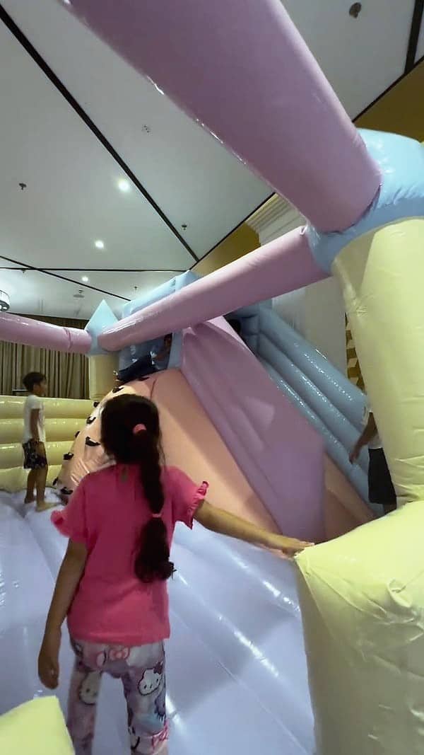 A pastel bouncy castle set up indoors